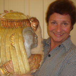 Brigitte holding a gold gilding Egyptian plaque