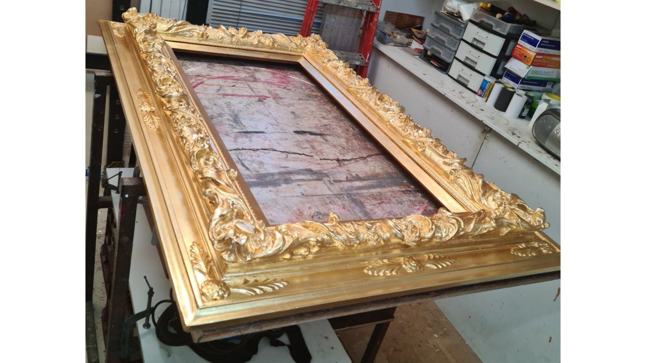 Gold gilded ornate picture frame.