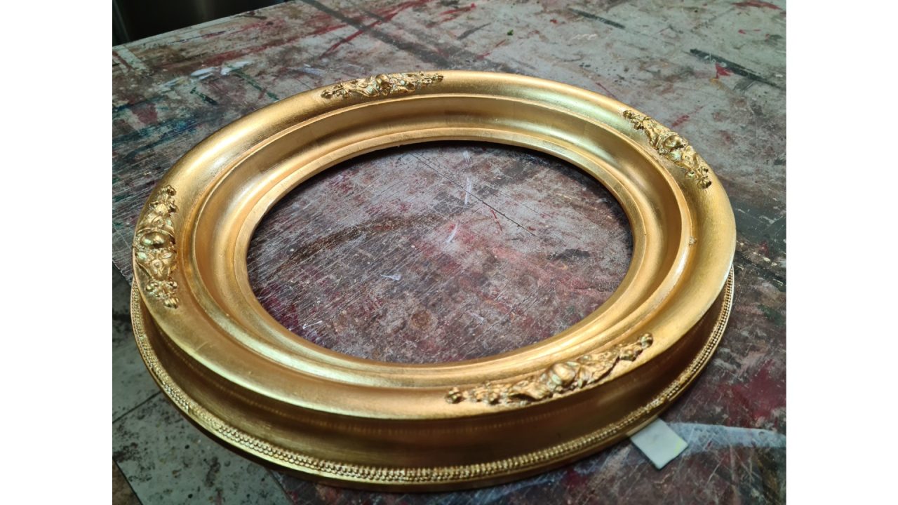 Ornate gold gilded circular frame.