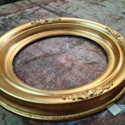 Ornate gold gilded circular frame.