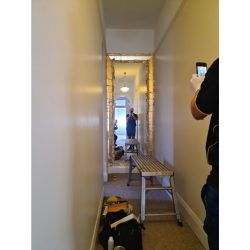 Preparing a hallway frame for gold gilding.