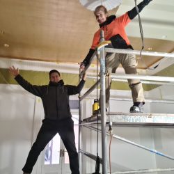 Krissie and Steve applying faux gold leaf over a sprawling 30-square-meter ceiling.