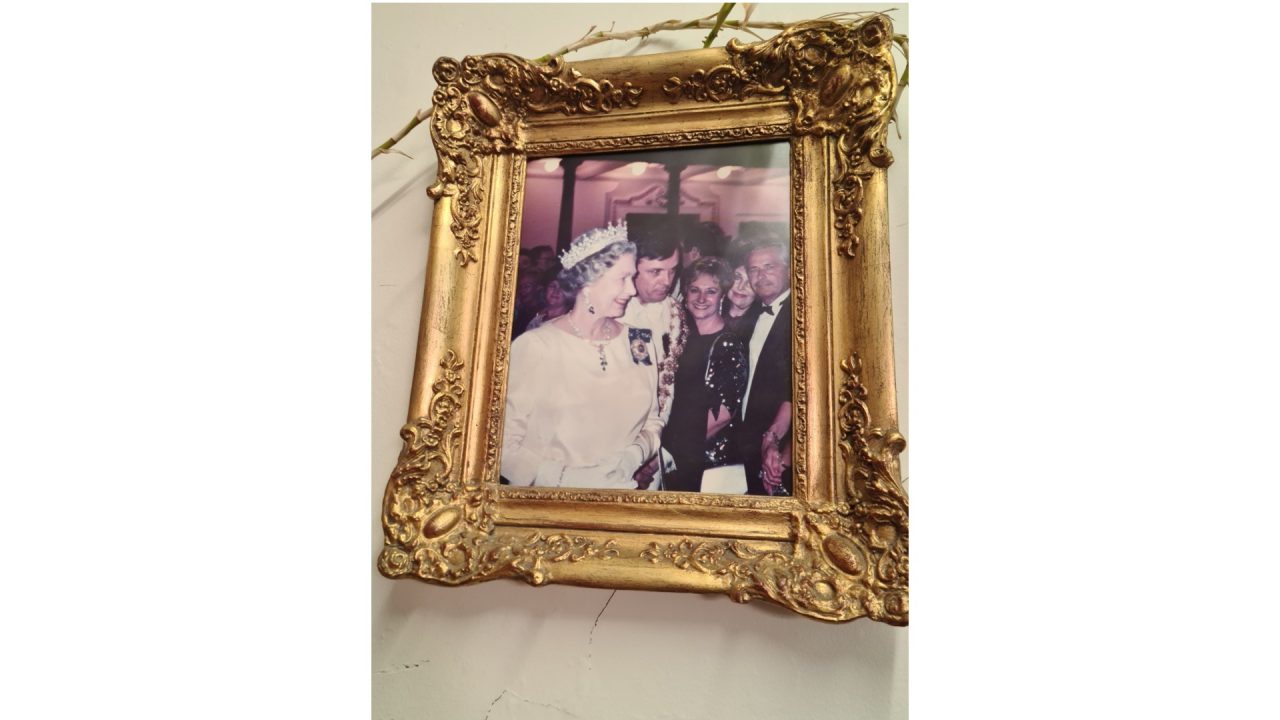 Gilded picture frame of Brigitte with The Queen.