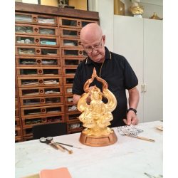 Karl gilding a statue.