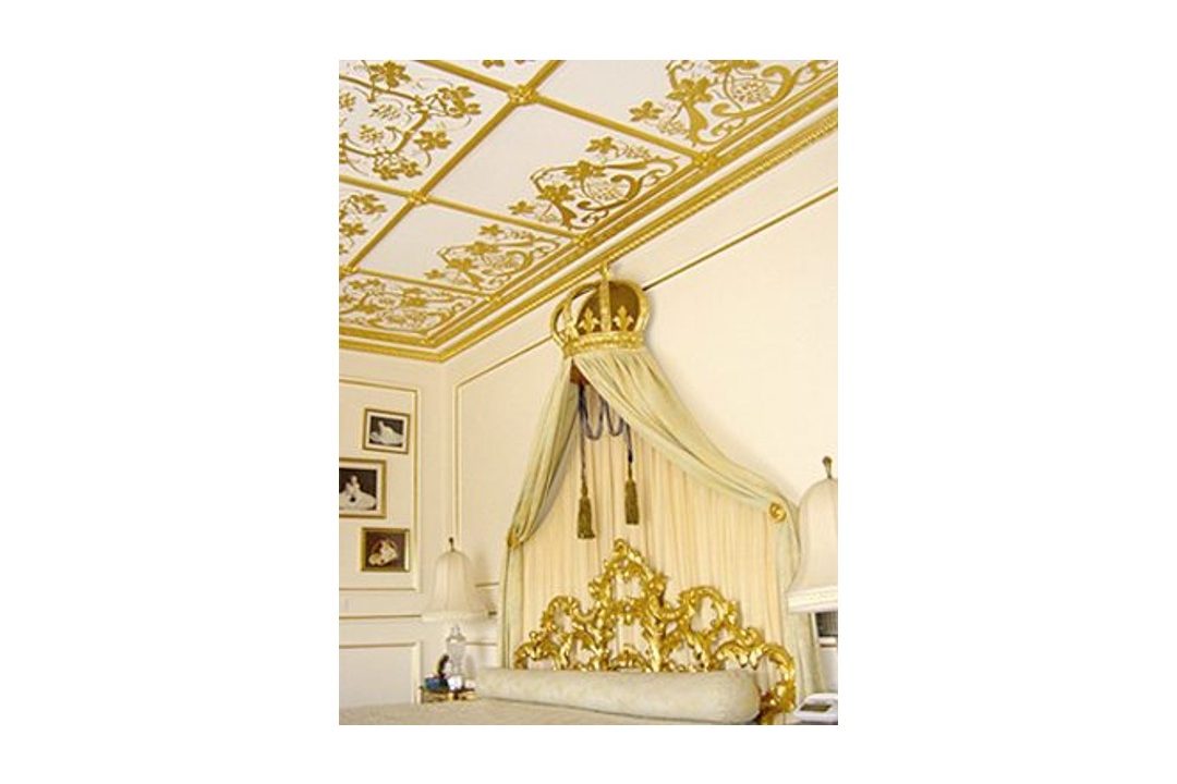 A gold gilded bedroom and ceiling.