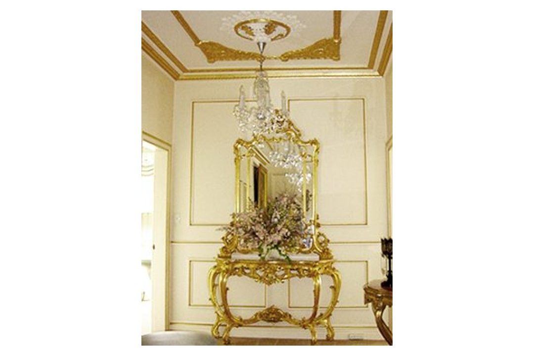 A gold gilded console table and mirror.