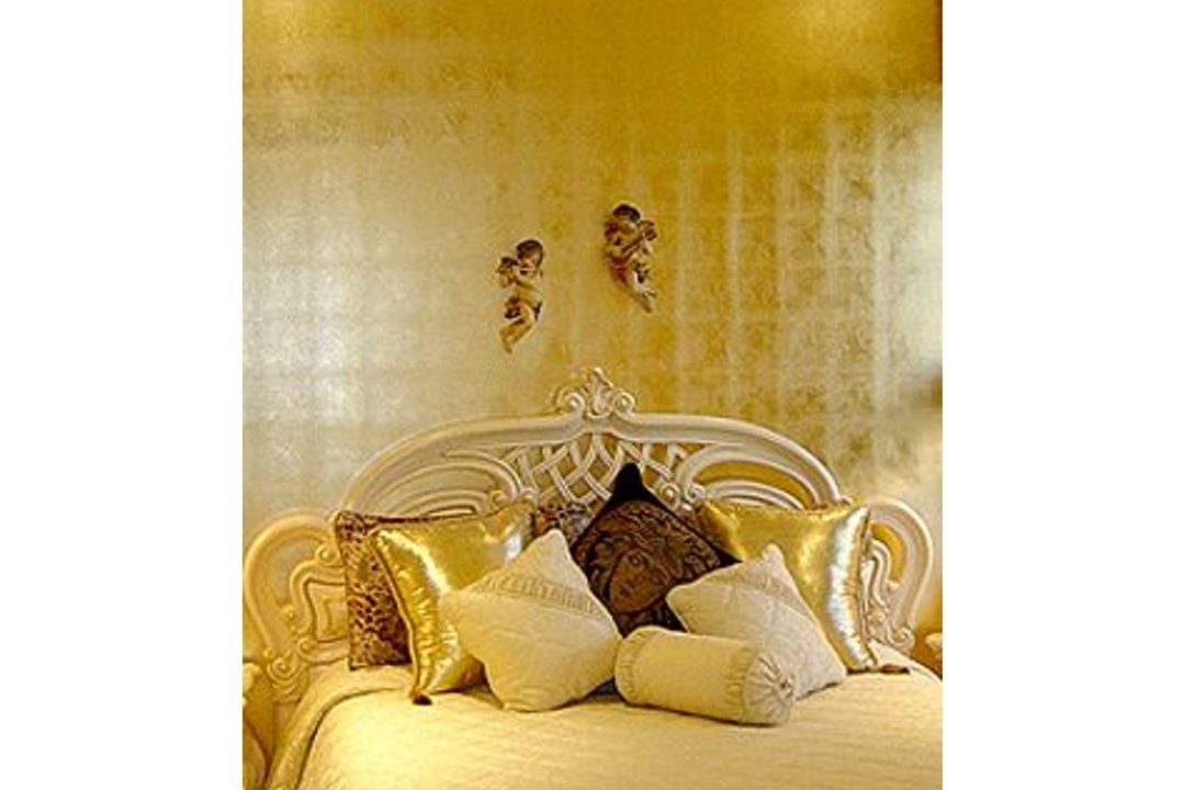 A gold-leafed bedroom wall.