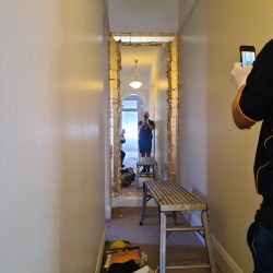 Preparing a hallway frame for gold gilding.