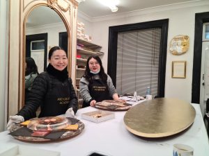 Two students are learning gilding during the Art Gilding Masterclass.