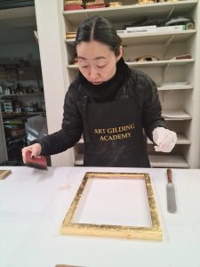 A student learning gilding during the Art Gilding Masterclass.
