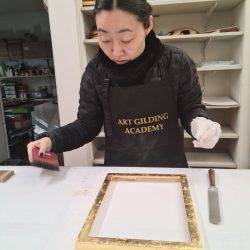 A student learning gilding during the Art Gilding Masterclass.