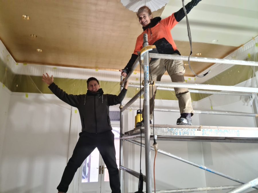 Krissie and Steve applying faux gold leaf over a sprawling 30-square-meter ceiling.